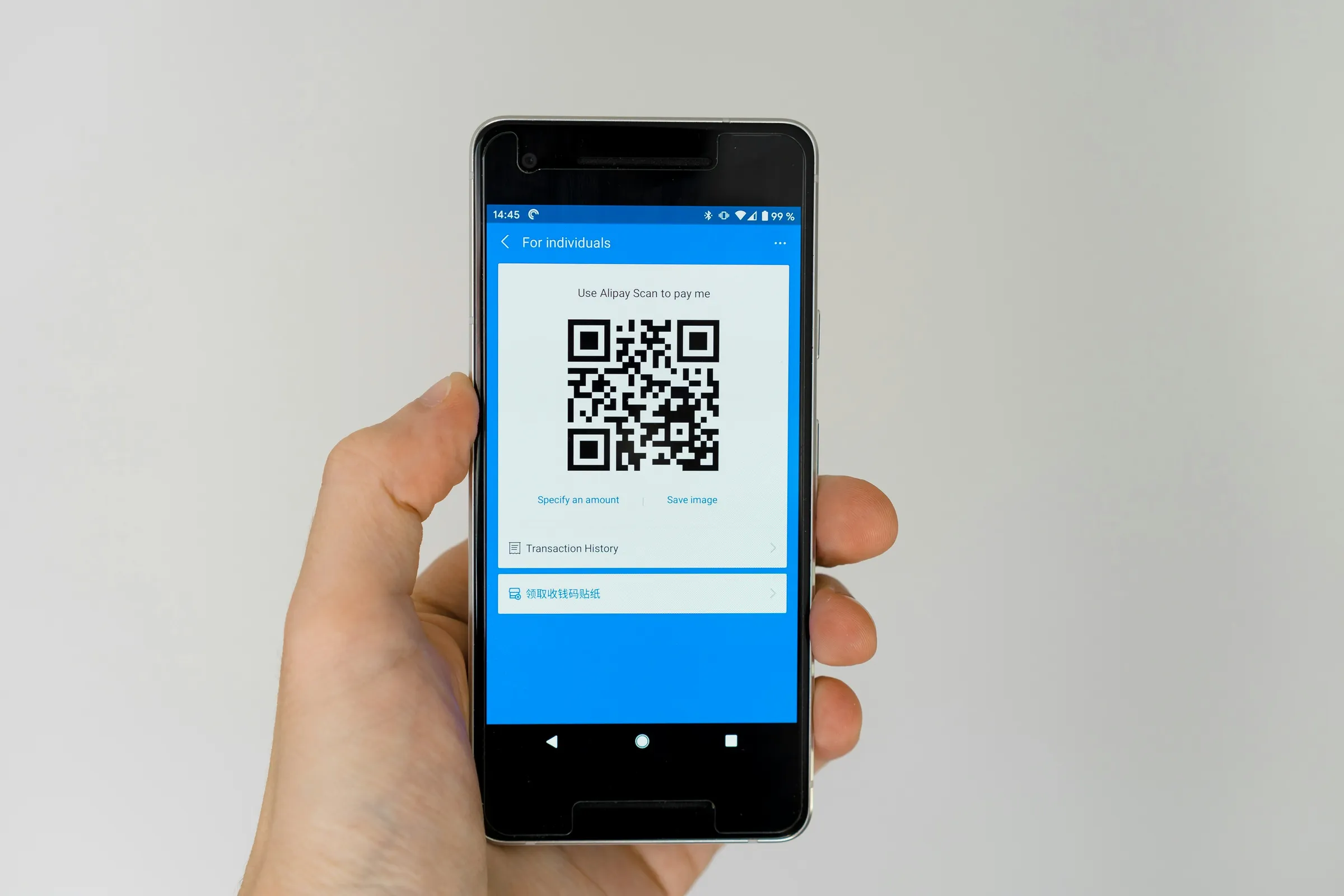 Smartphone scanning a QR code at a pool equipment pad
